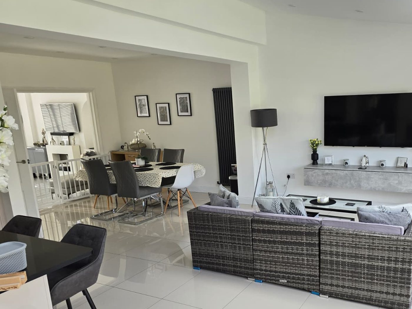 An open-plan living and dining space completed by GS Renovation, lit by a roof lantern