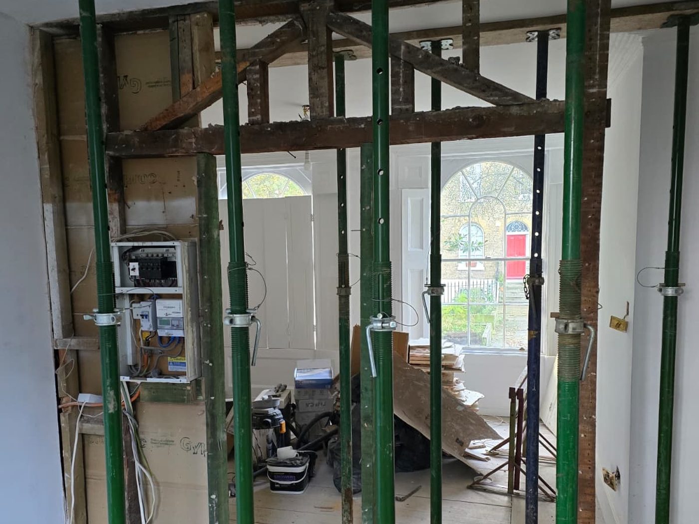 A propped structural opening in a period terrace, carried out by GS Renovation, with the original timber lintel exposed