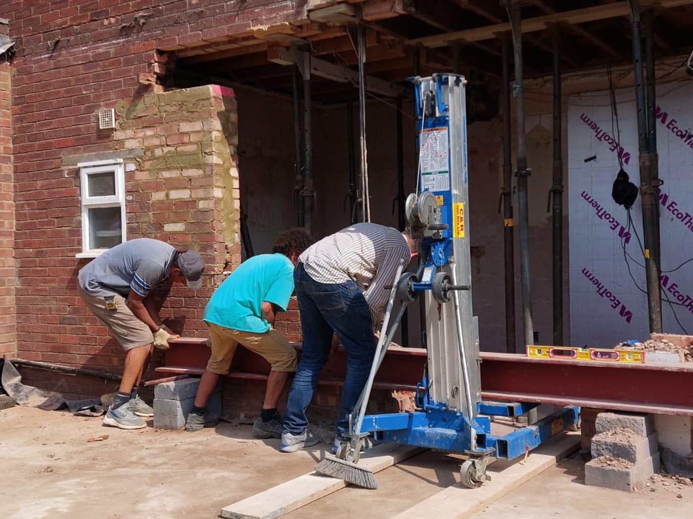 A steel beam being lifted into a propped structural opening by GS Renovation